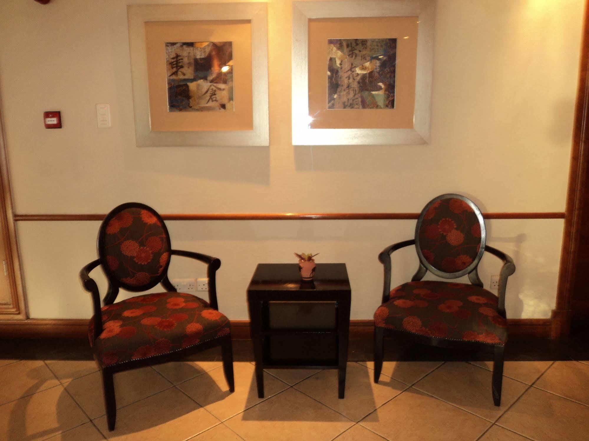 Taj Pamodzi Lusaka Exterior photo Two chairs in a hotel lobby